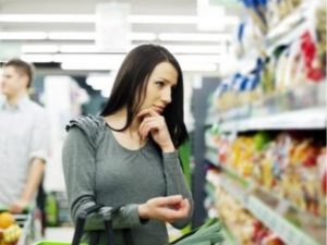 Consumer looking at supermarket shelves